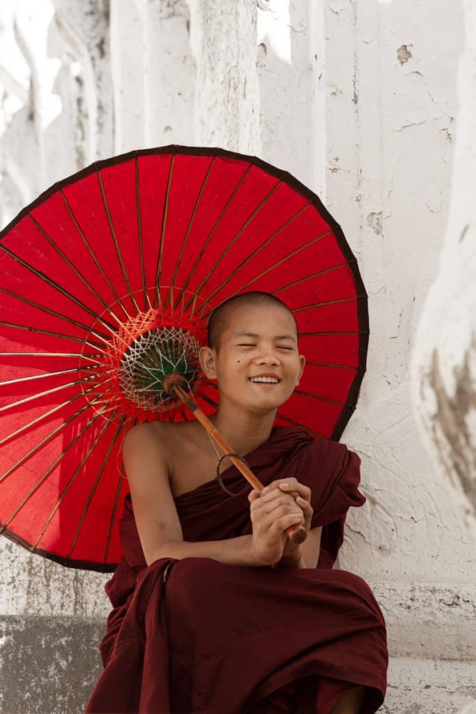 A young monk laughing in Hsinbyume Pagoda in Mingun, Mandalay