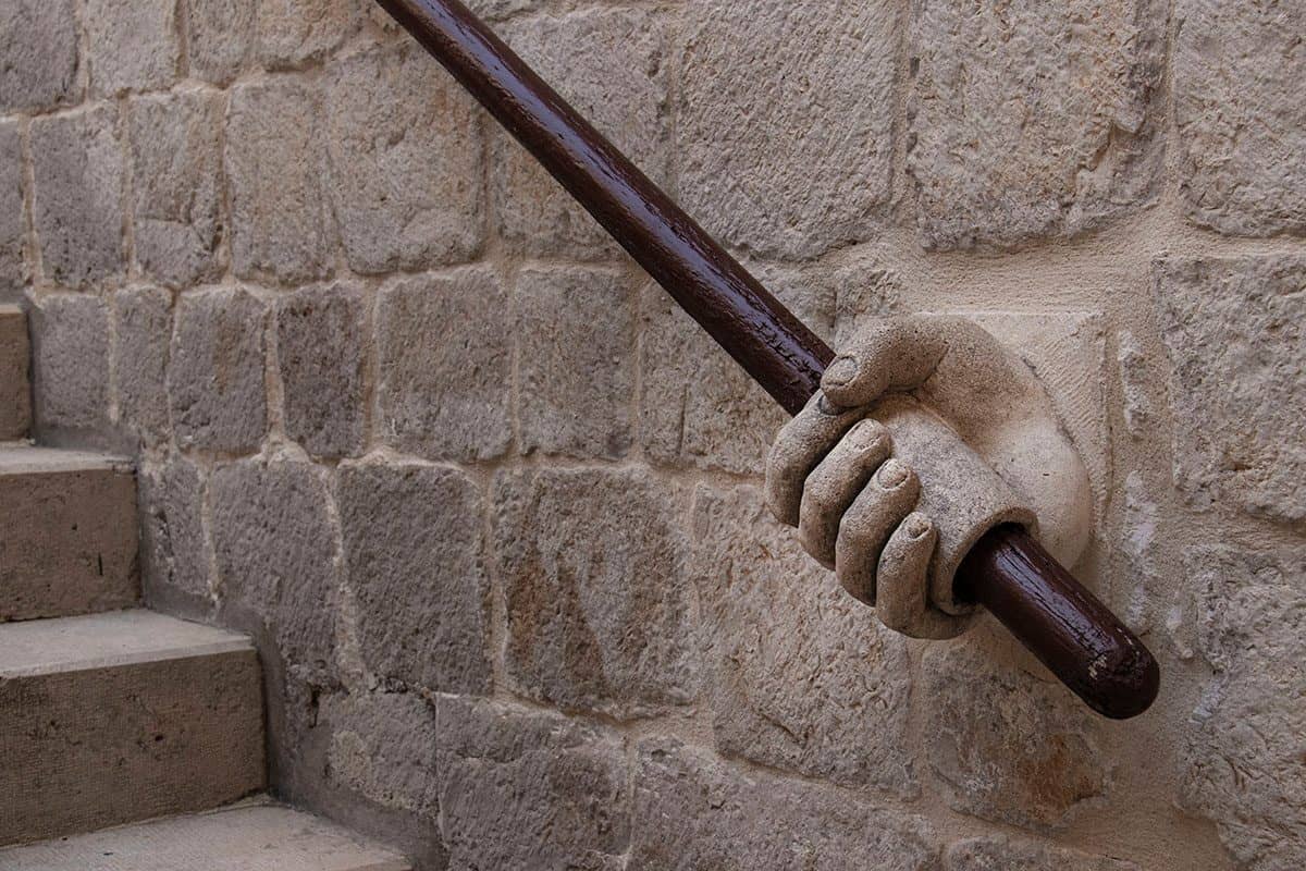 A unique hand-shaped stair rail in Dubrovnik