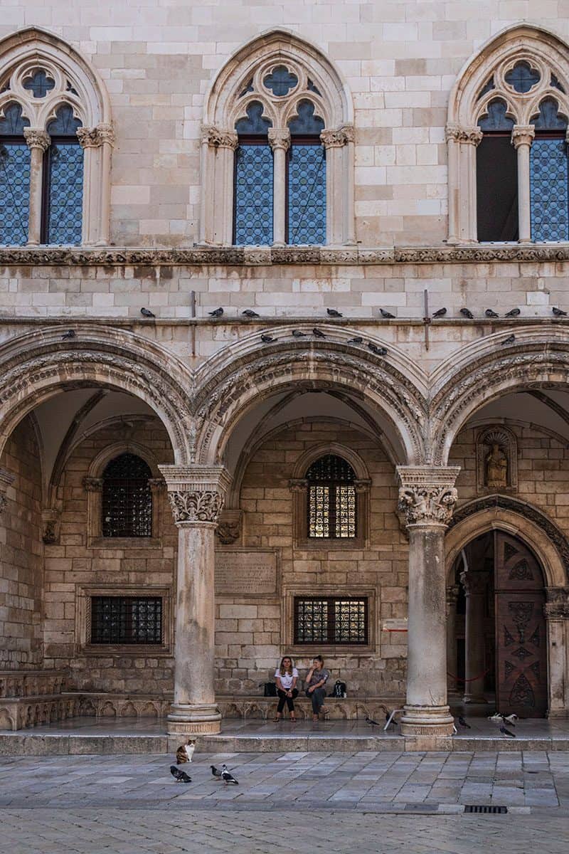 Two women sits on decorated benches in Dubrovnik's Rector's Palace