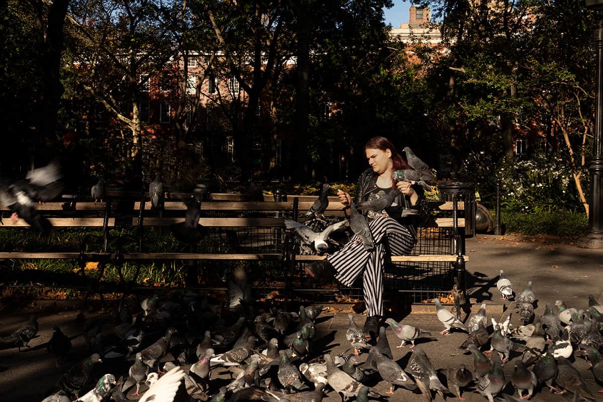 A women Feeding the birds in Washington square park greenwichvillage