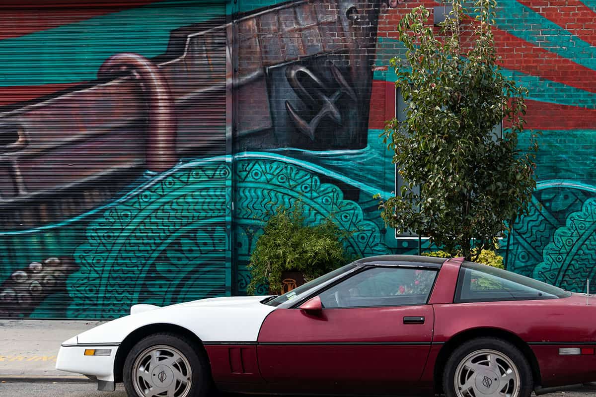 Vintage car on a colorful street art in Bushwick Brooklyn