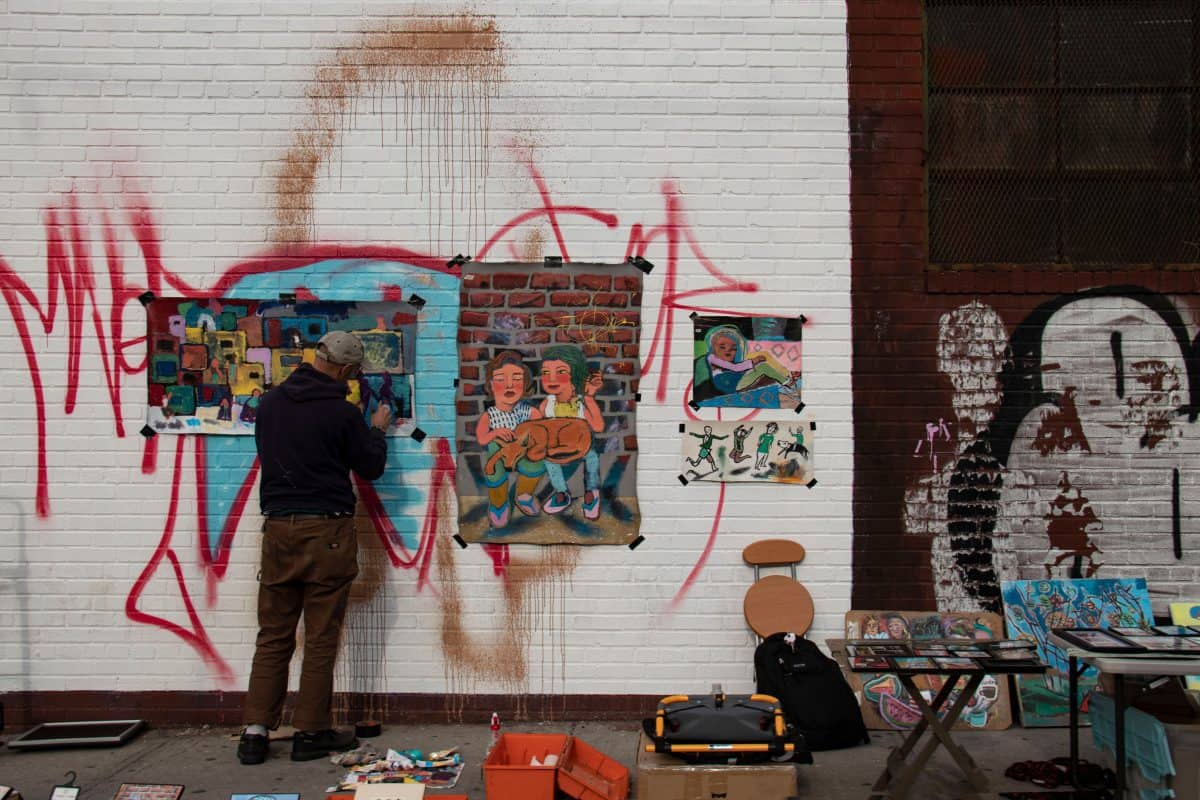 A man paint on one of Bushwick's wall in Brooklyn