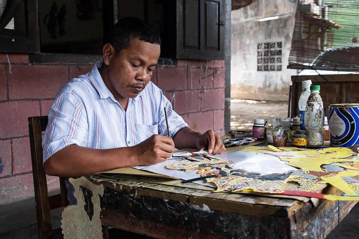 A Wayang artist making Puppets in Java